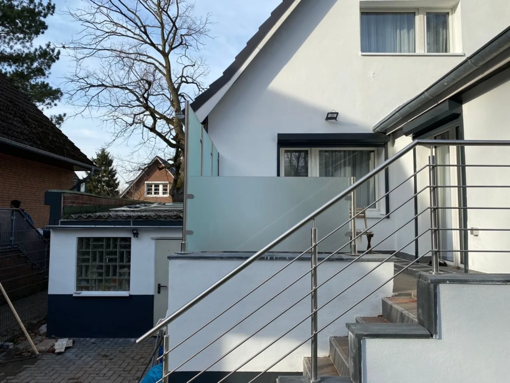Außentreppe mit Edelstahlgeländer und Milchglas-Element an Wohnhaus